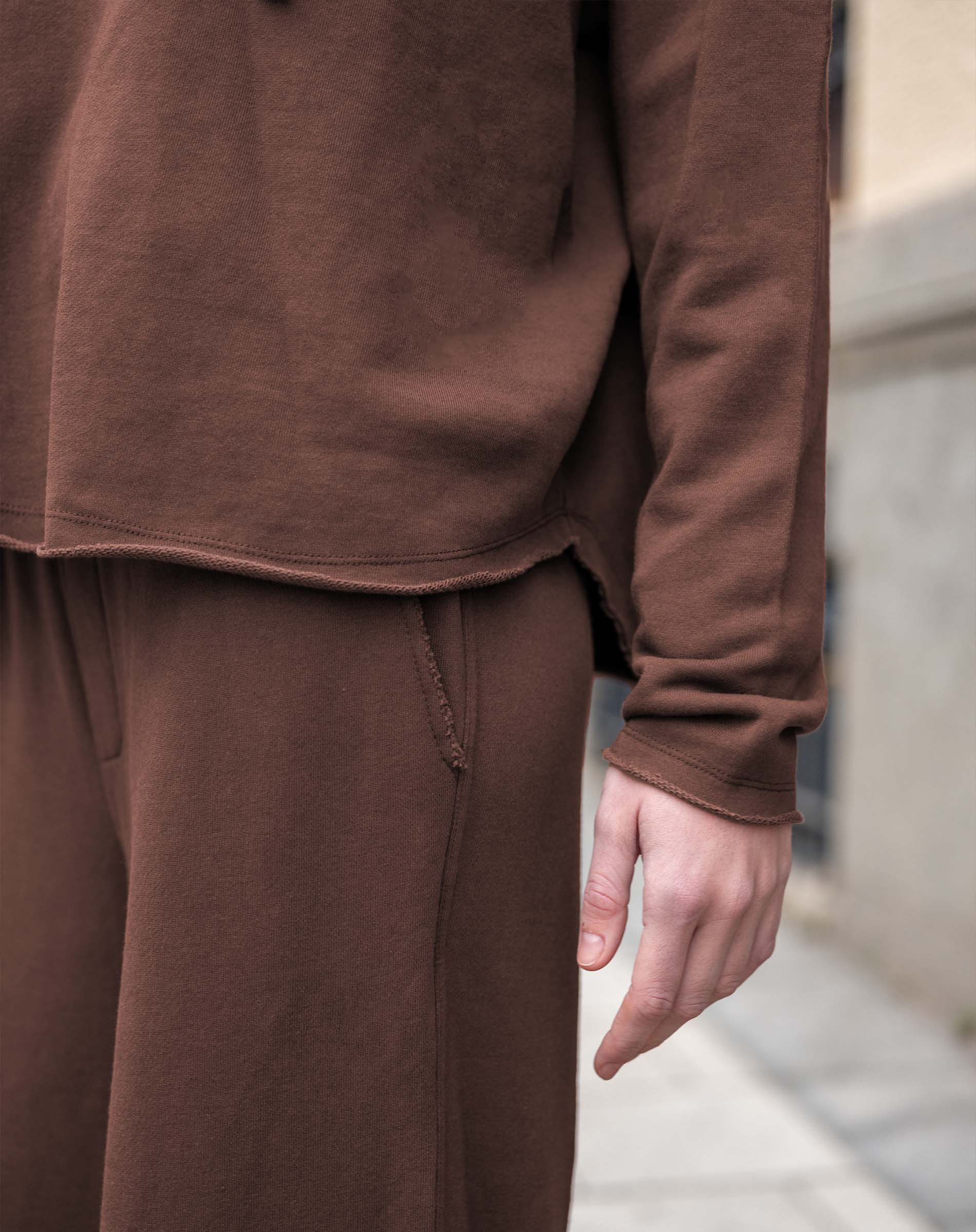 Espresso brown knit hoodie and matching wide-leg trousers.