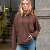 Espresso brown oversized hoodie with a drawstring and relaxed fit.