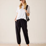 Black jogger pants with a cinched hem and side pockets.