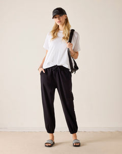 Black jogger pants with a cinched hem and side pockets.