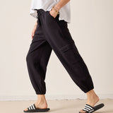 Black jogger-style pants with a cargo pocket and cinched cuffs.
