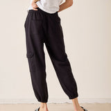 Black jogger-style pants with cargo pockets and elastic cuffs.