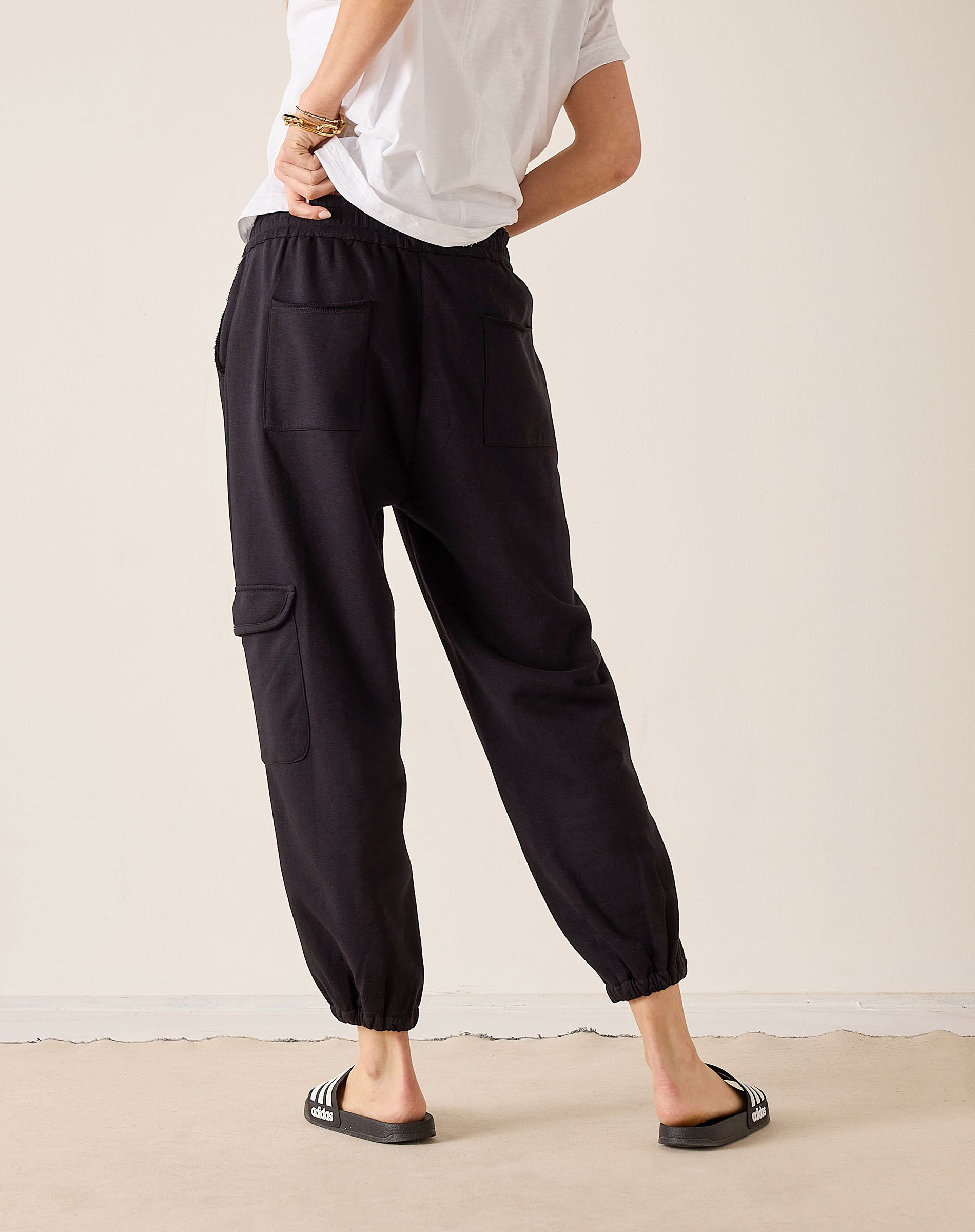 Black jogger-style pants with cargo pockets and elastic cuffs.