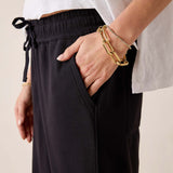 Black Frenchie joggers with an elastic waistband and drawstring.