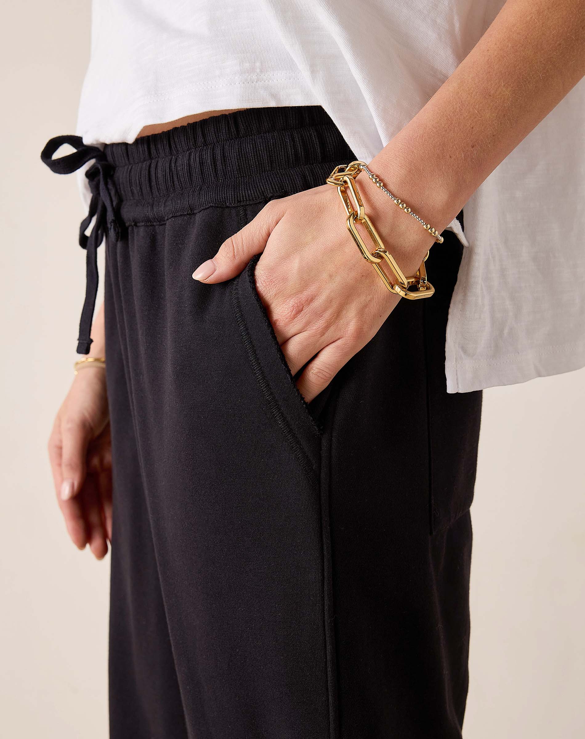 Black Frenchie joggers with an elastic waistband and drawstring.