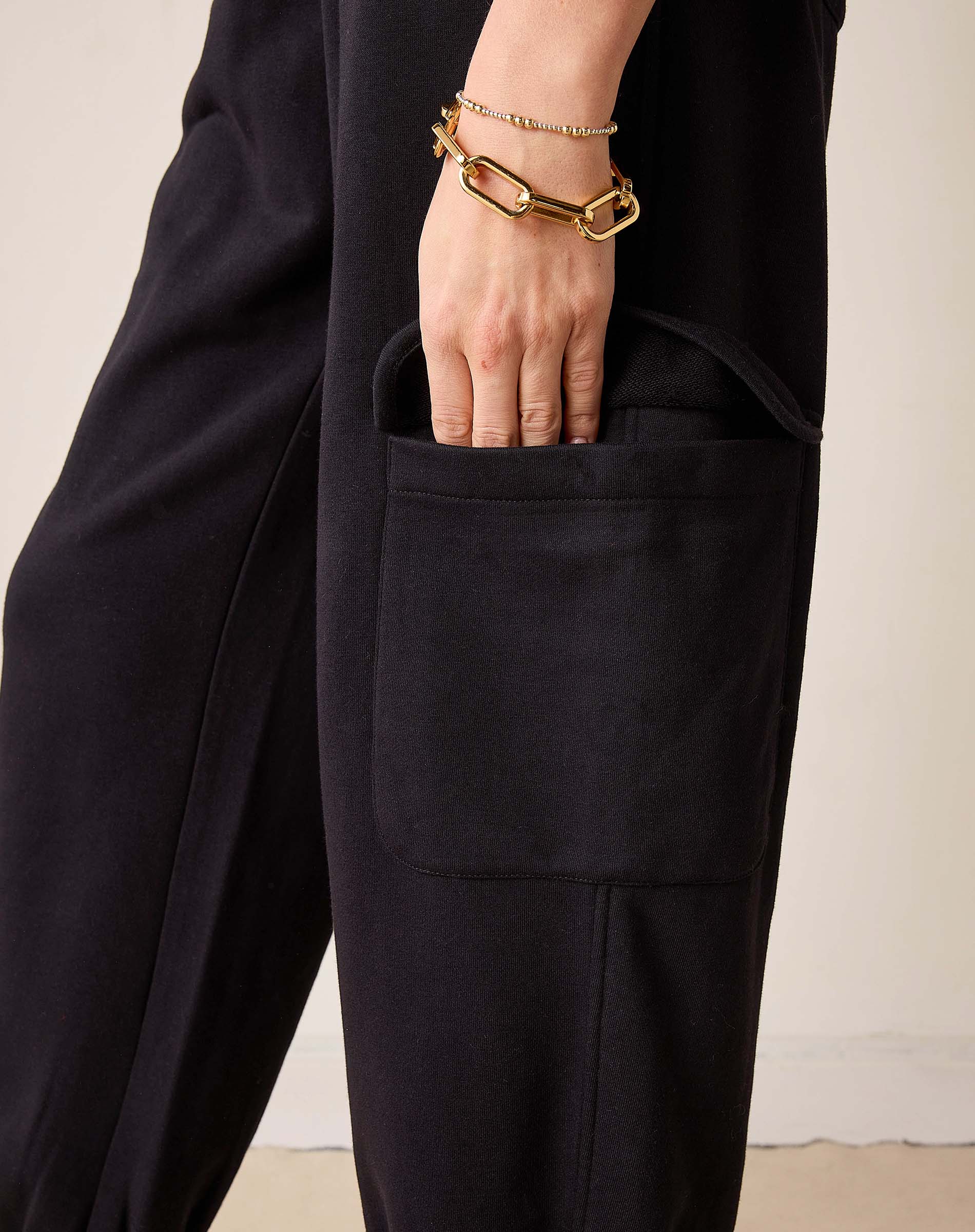 Black Frenchie jogger pants with a large front pocket and relaxed fit.