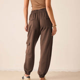 Espresso jogger pants with large front pockets and gathered hems.