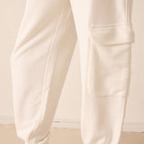 Close-up of beige pants on a neutral background