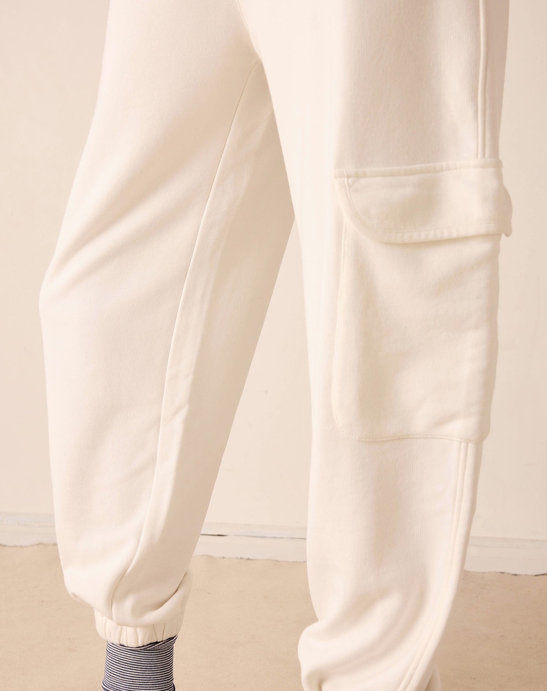 Close-up of beige pants on a neutral background
