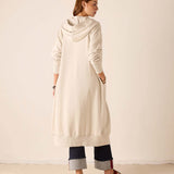 Back view of the bone-colored maxi hoodie with a large hood and ribbed cuffs.