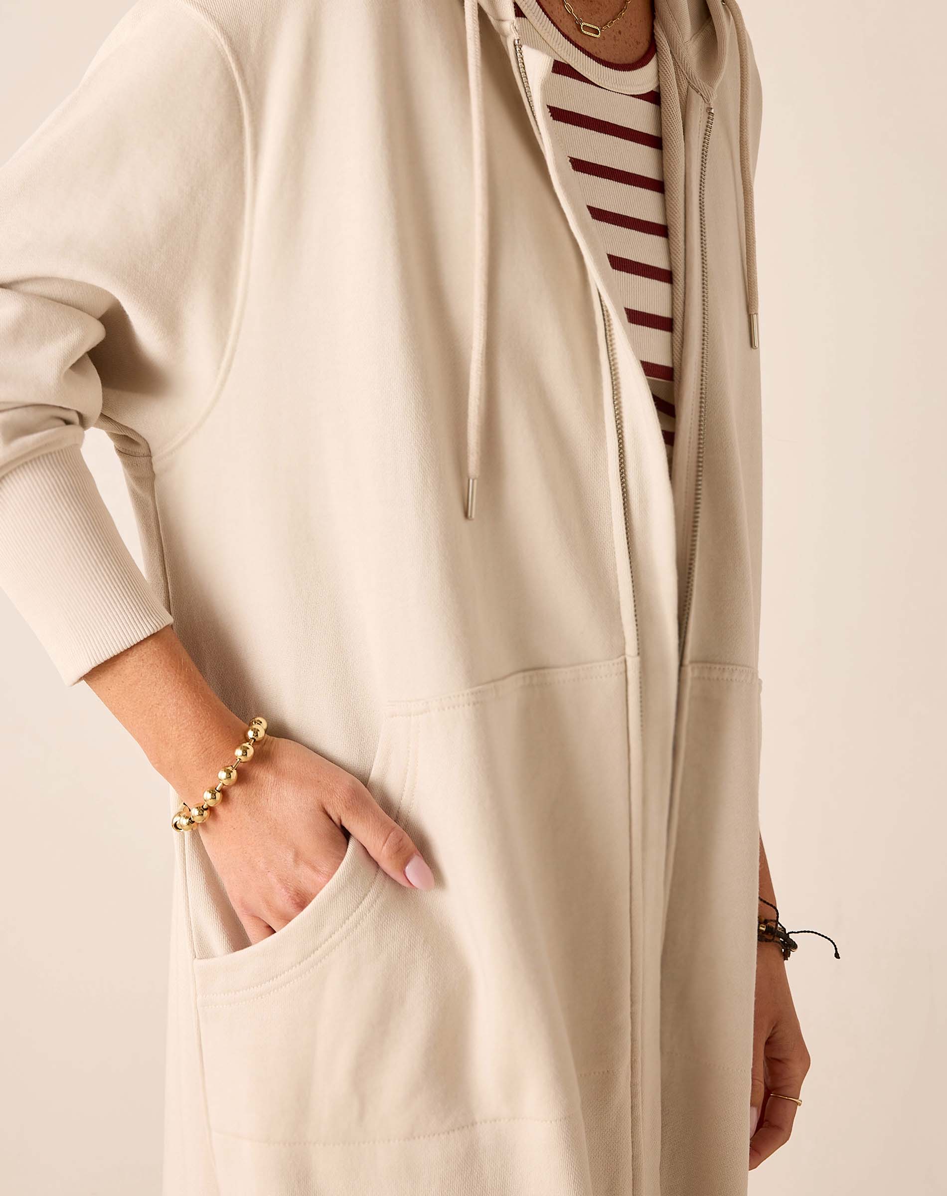 Bone maxi hoodie with a front zipper and drawstring hood.