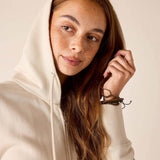 Bone hoodie with a drawstring hood and cozy knit fabric.