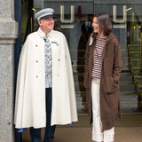Espresso maxi hoodie with hood and front pocket worn by a woman in a city setting.