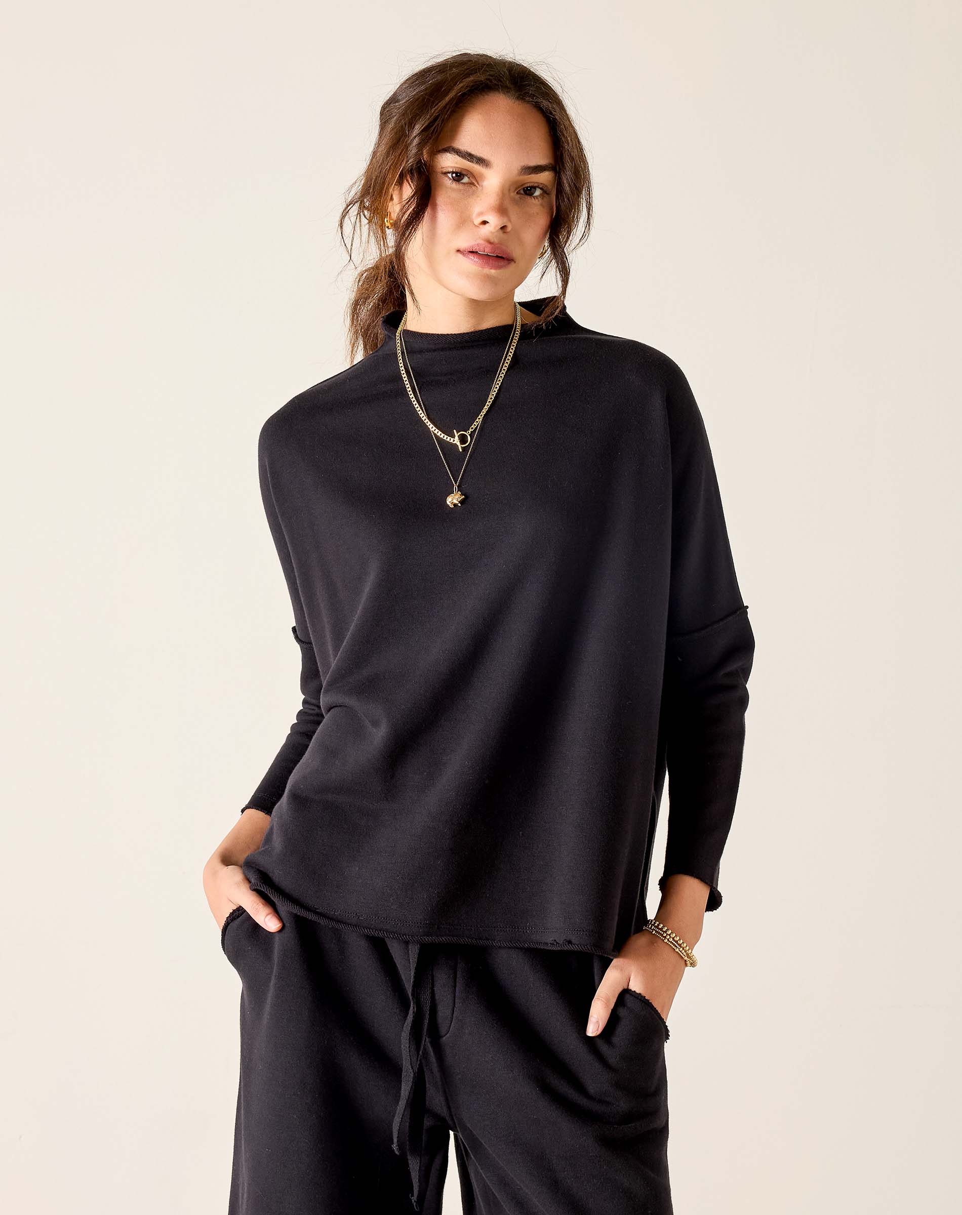 Black mockneck knit top with a relaxed fit.
