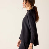 Black mockneck tunic with long sleeves and a relaxed fit.