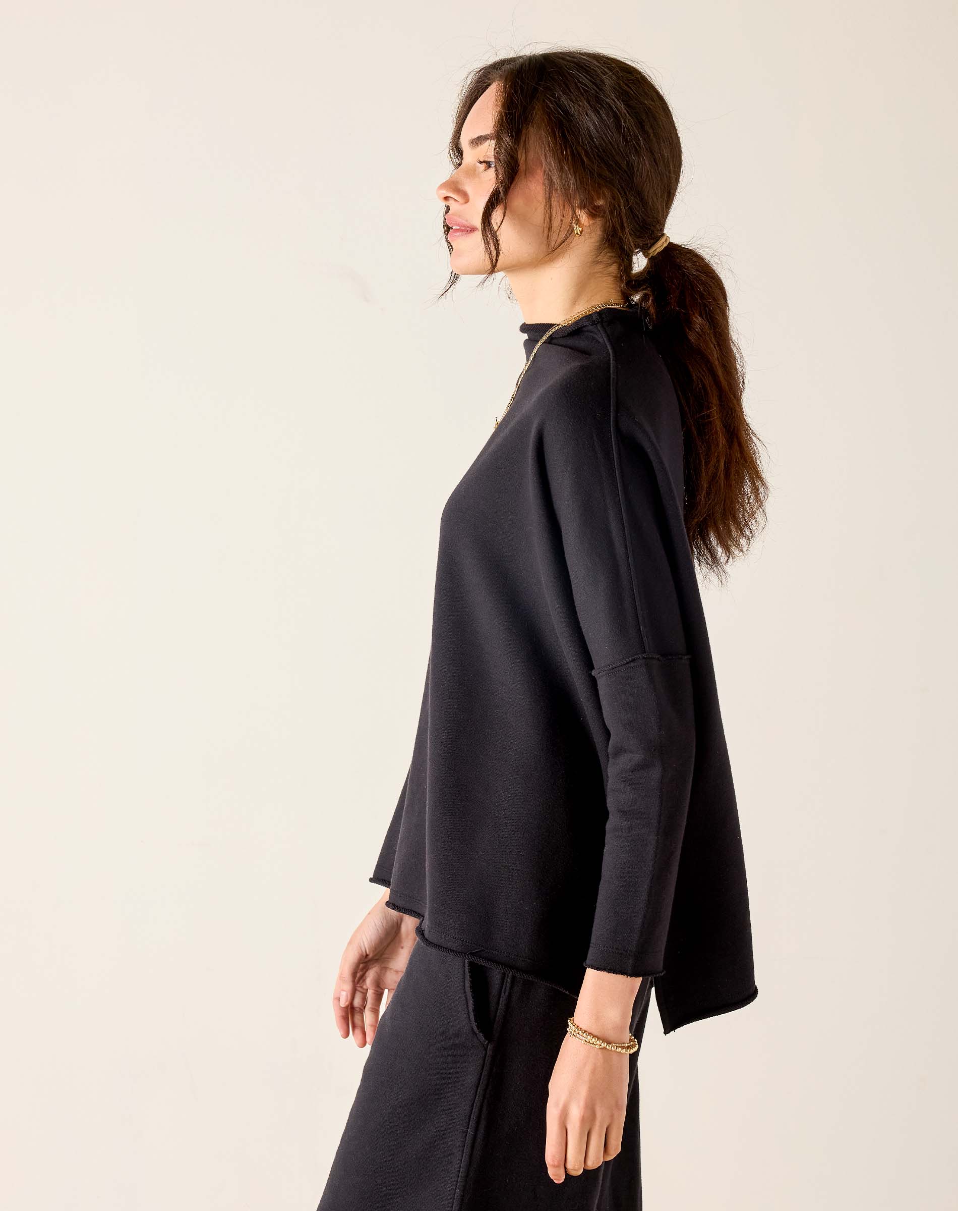 Black mockneck tunic with long sleeves and a relaxed fit.