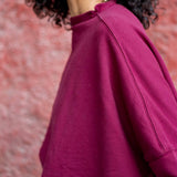 Women's travel-friendly winterberry mockneck knit top with a relaxed fit and long sleeves.