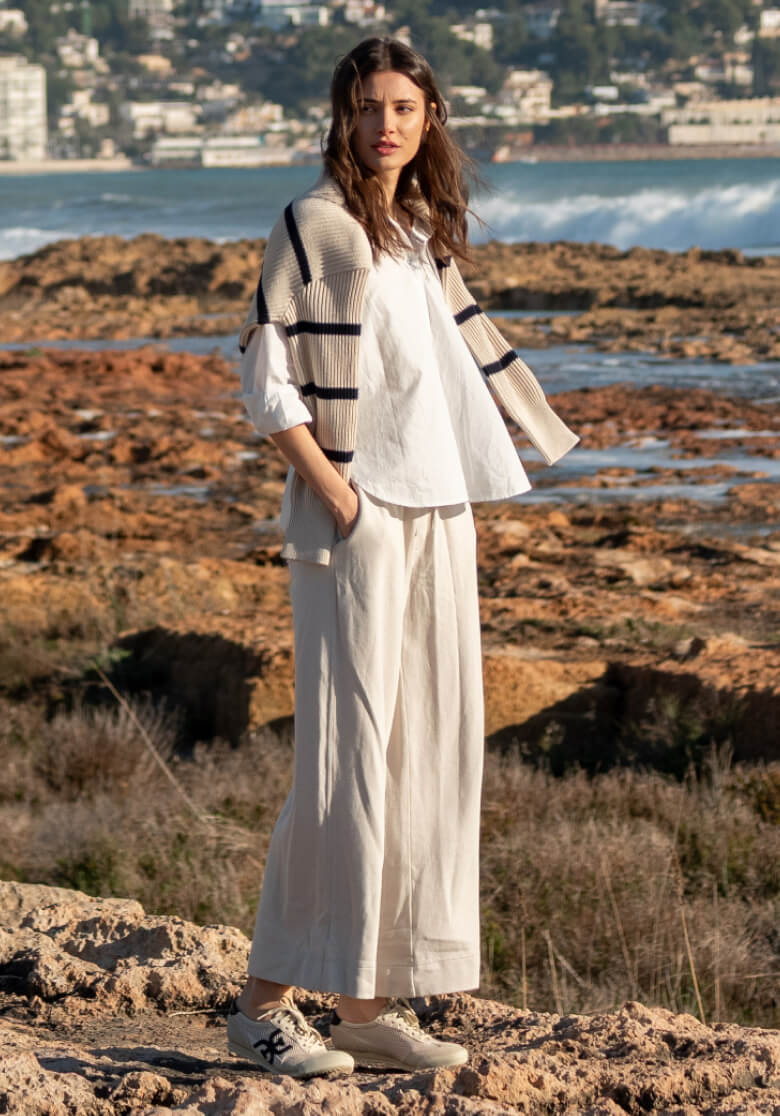 Image of a woman wearing an off-white travel set