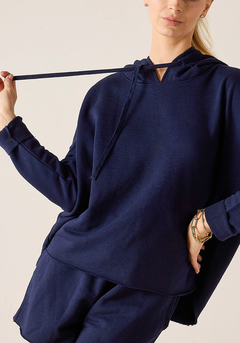 Image of a woman wearing a blue French terry travel set