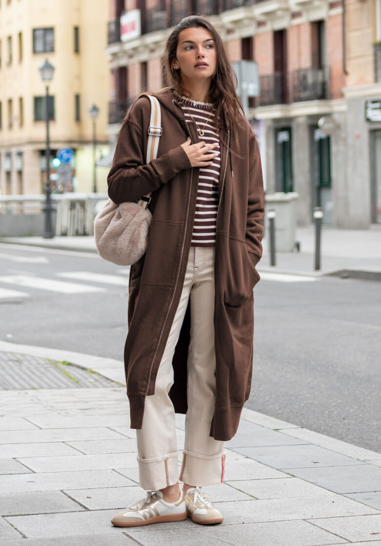 Image of a woman wearing a brown maxi hoodie.
