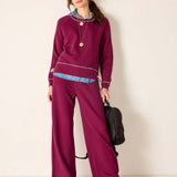 MERSEA ladies' travel-ready berry red knit set featuring a long-sleeved top and wide-leg pants with ribbed detailing.