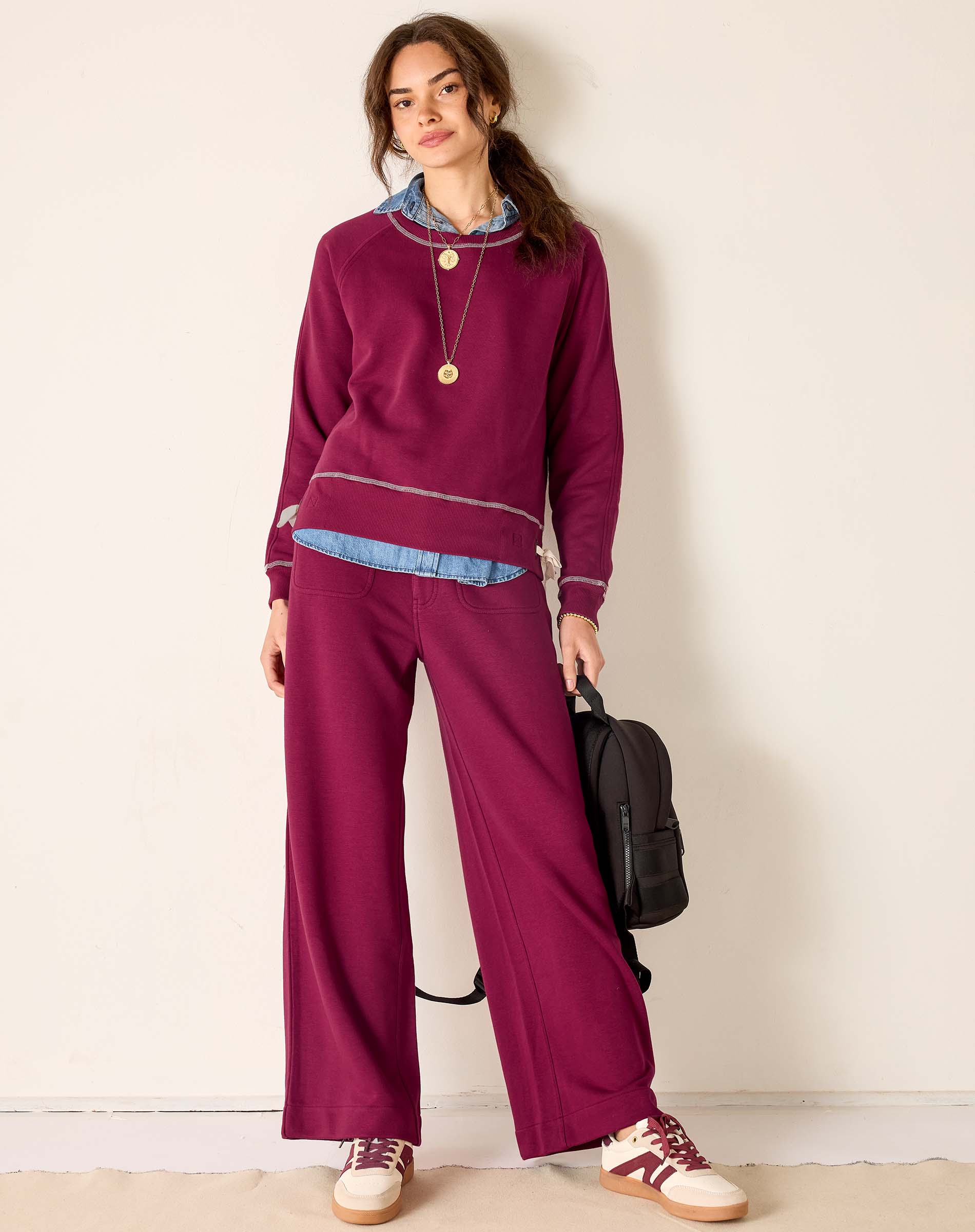 MERSEA ladies' travel-ready berry red knit set featuring a long-sleeved top and wide-leg pants with ribbed detailing.