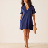 Woman wearing a blue dress against a plain background