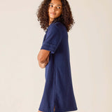 Woman wearing a blue dress against a plain background