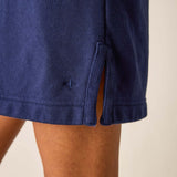 Navy blue shorts on a person against a beige background