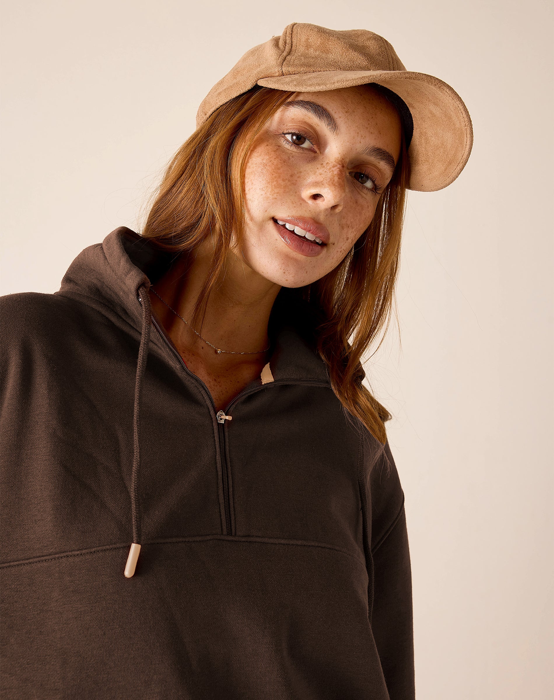 Ladies' travel-ready espresso brown quarter-zip pullover with a ribbed texture and hood.