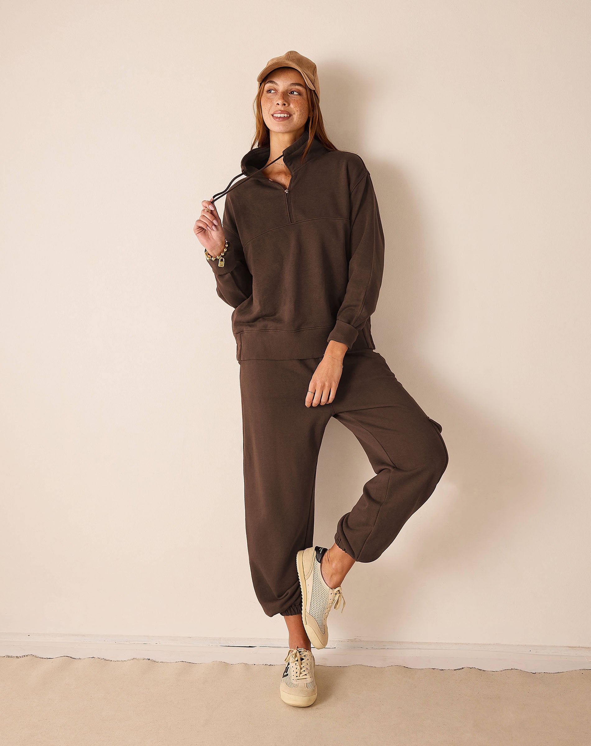 Espresso brown knit quarter-zip pullover with relaxed fit.