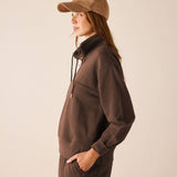 Espresso brown quarter-zip knit top featuring a stand collar and relaxed fit.