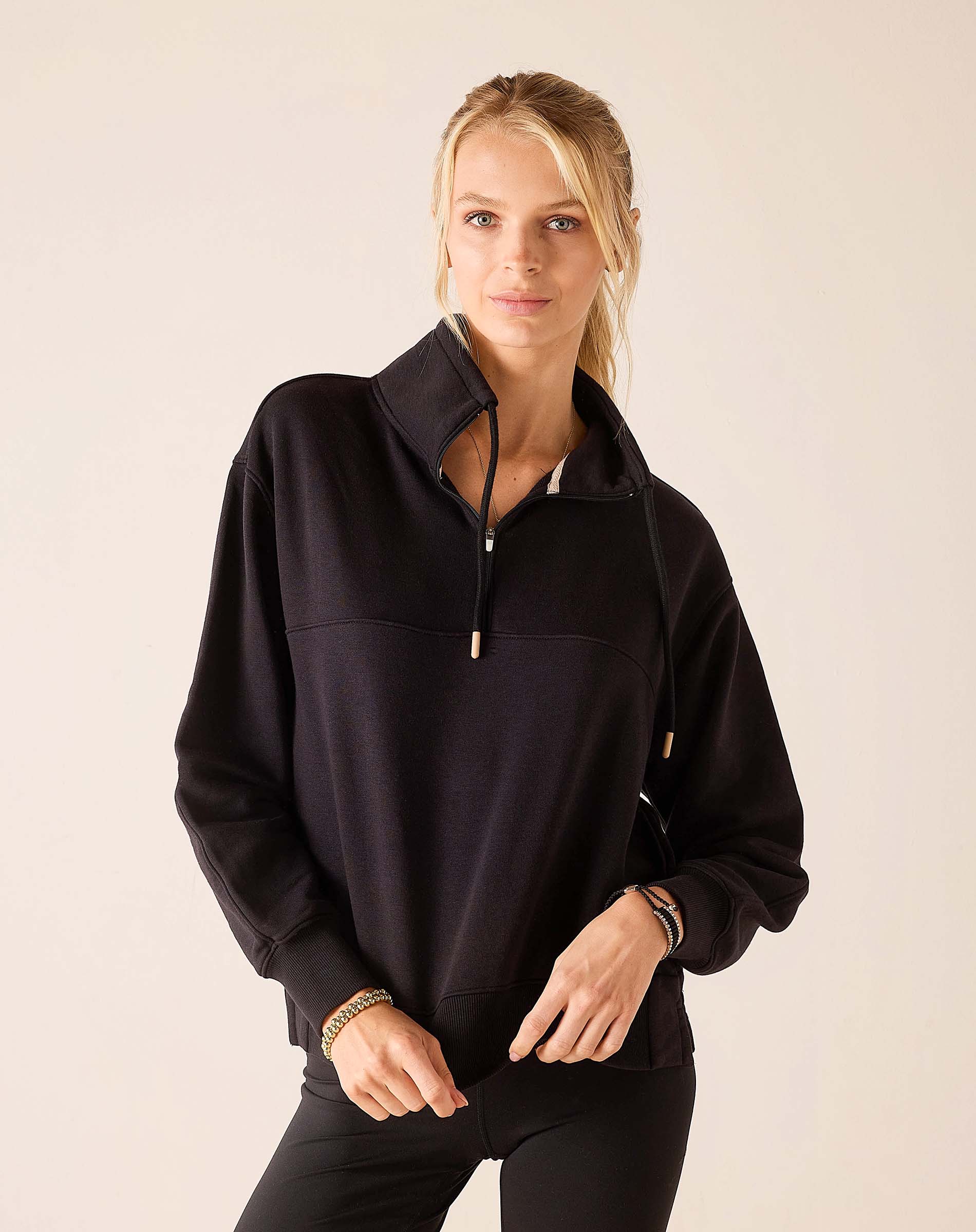 MERSEA ladies' travel-ready black quarter-zip sweatshirt with a tall collar and athletic fit.