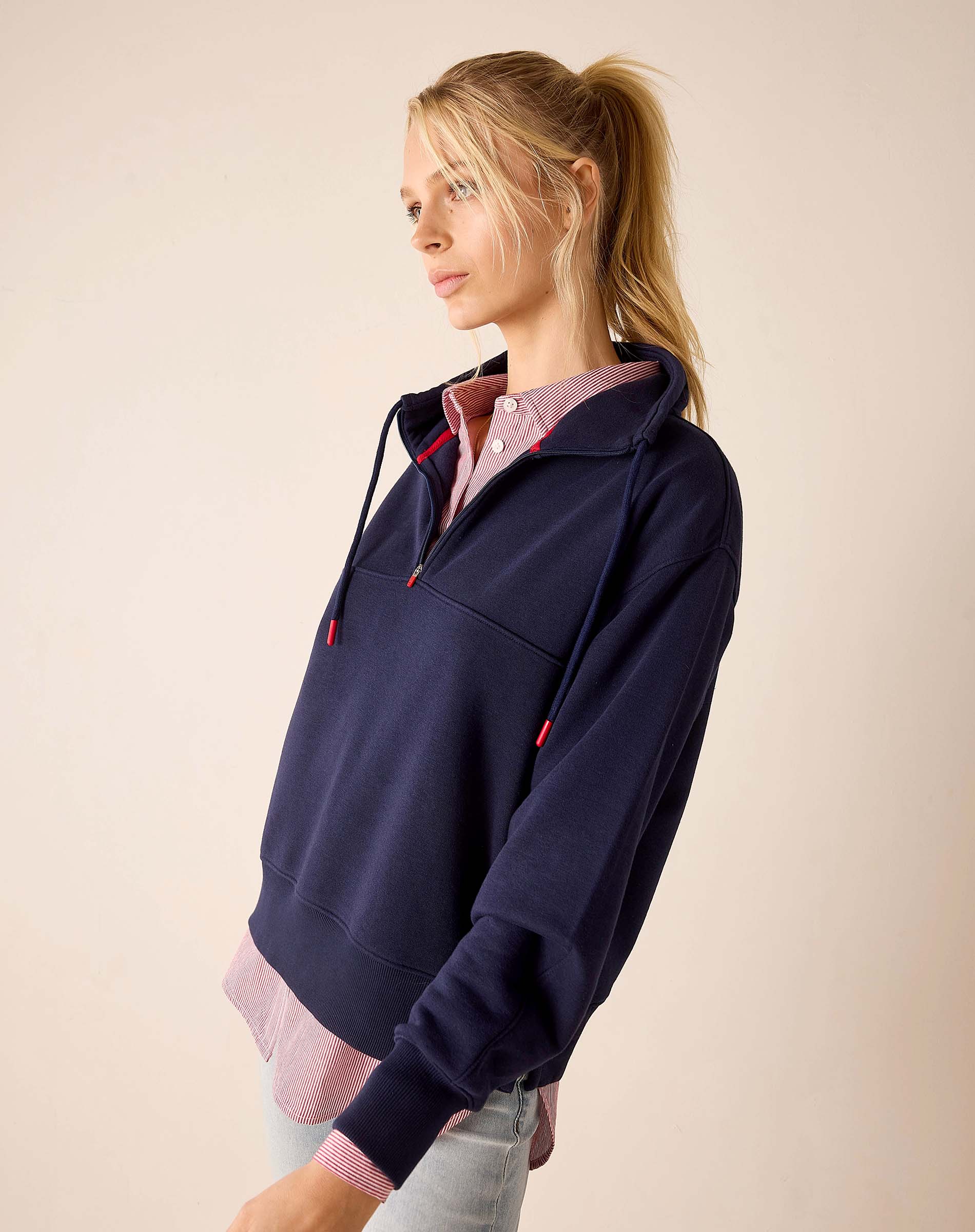 Cadet blue quarter-zip sweatshirt with a striped collar detail.