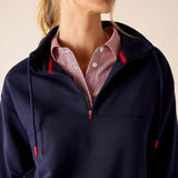 Cadet blue quarter-zip sweatshirt with red drawstring details and a striped button-down shirt underneath.