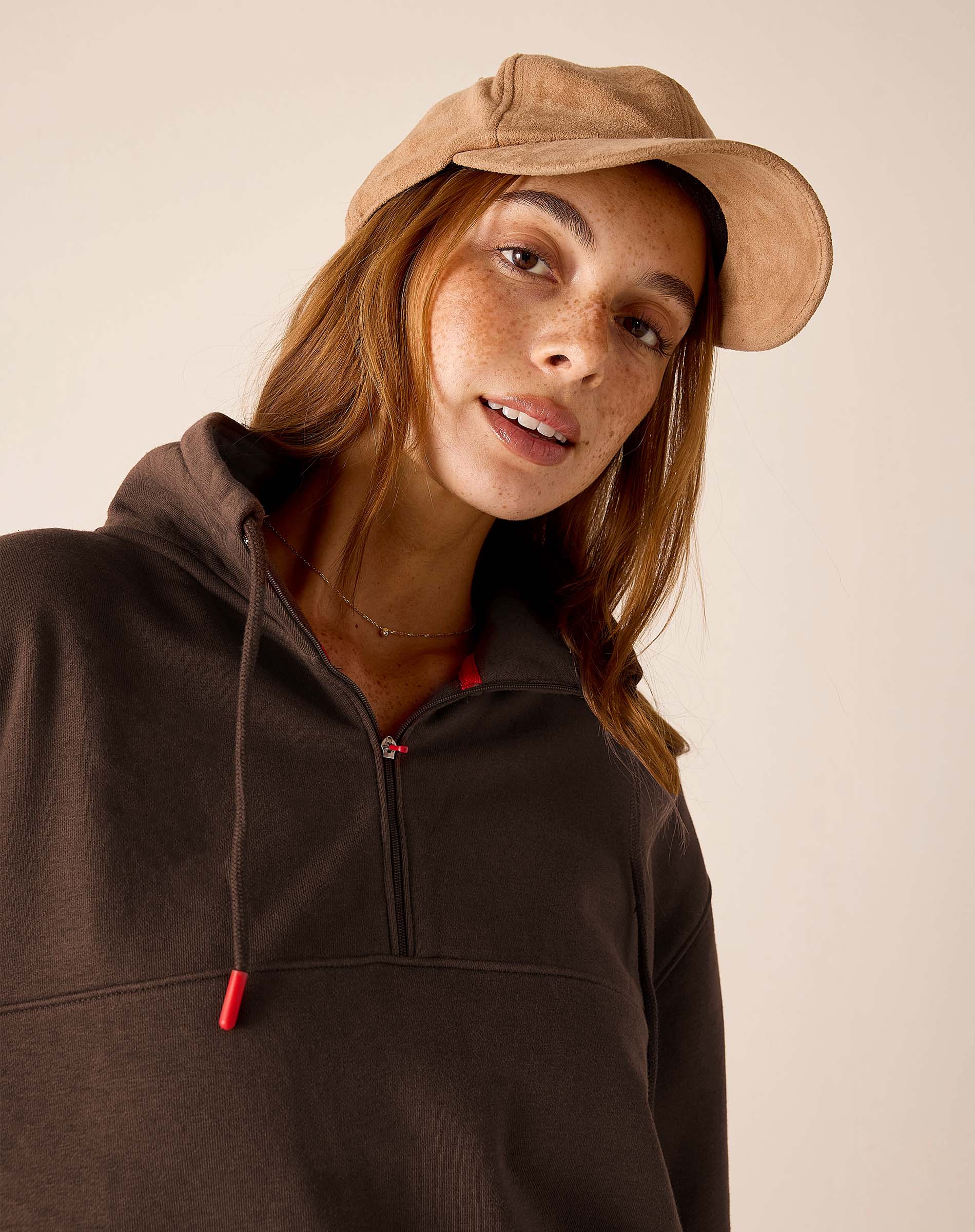 Espresso brown quarter-zip sweatshirt with red drawstring tips and a hood.