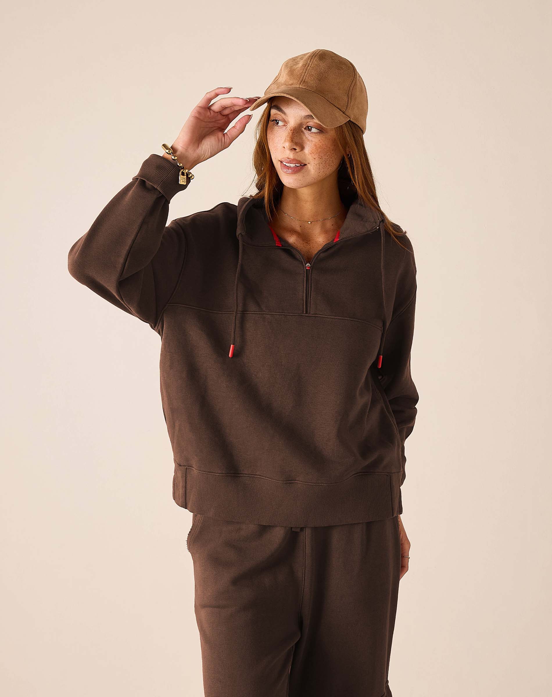 Espresso quarter-zip sweatshirt with a hood and matching joggers.