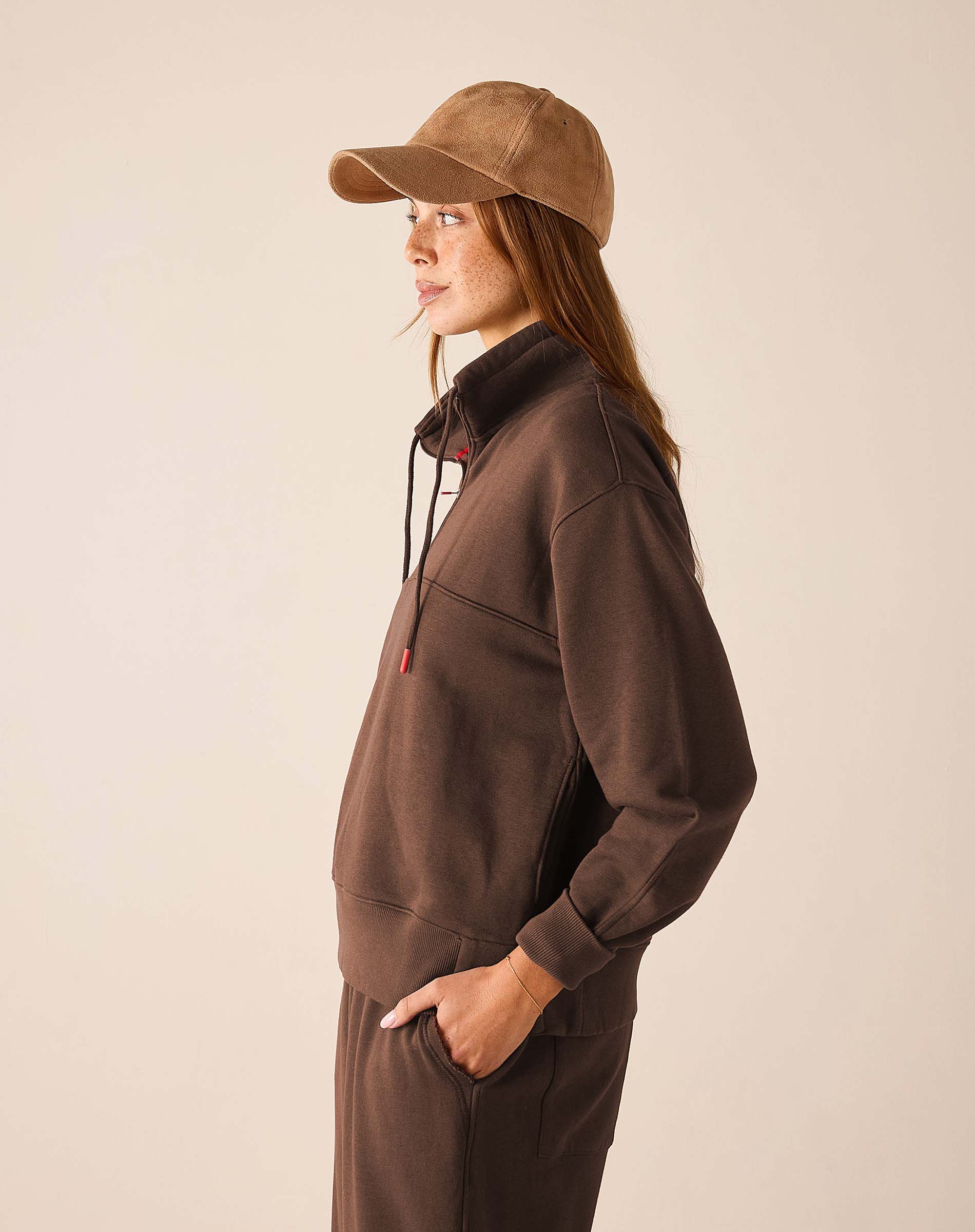 Espresso quarter-zip sweatshirt with a high collar and long sleeves.