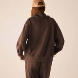 Back view of the espresso quarter-zip sweatshirt with a relaxed fit and ribbed cuffs.