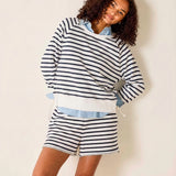 Woman wearing a striped outfit with a white background