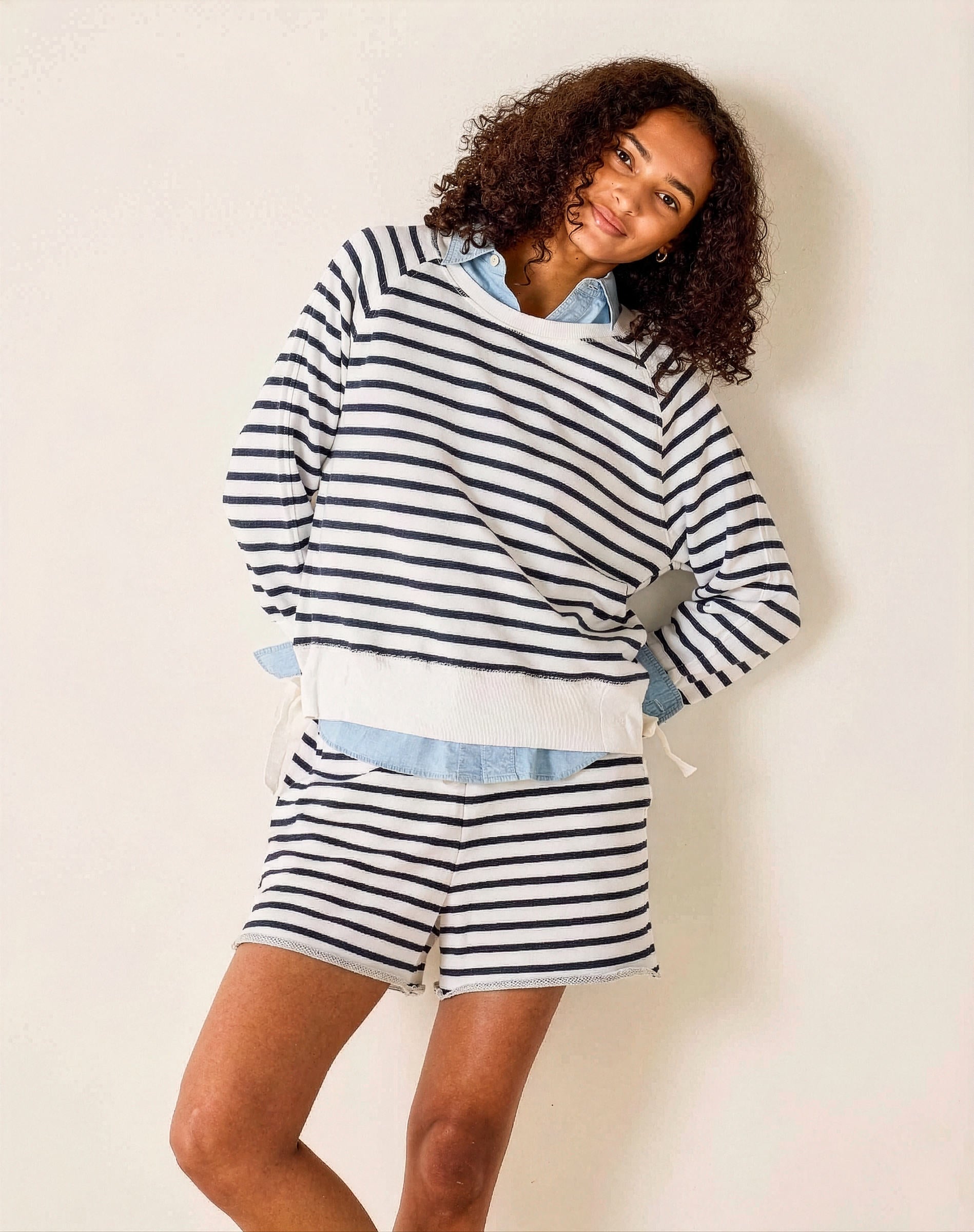 Woman wearing a striped outfit with a white background