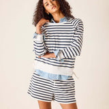 Woman wearing a striped outfit with a white background