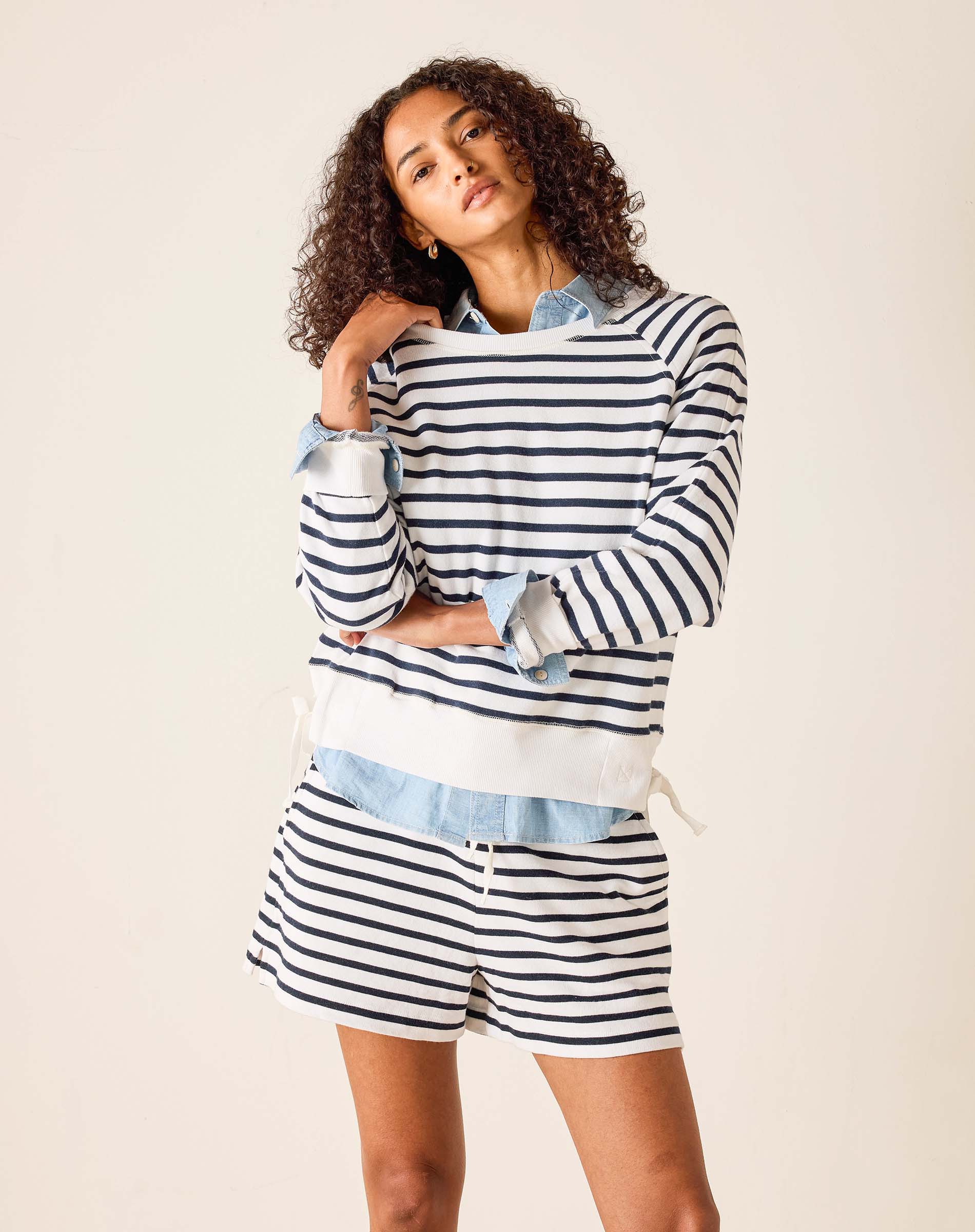 Woman wearing a striped outfit with a white background