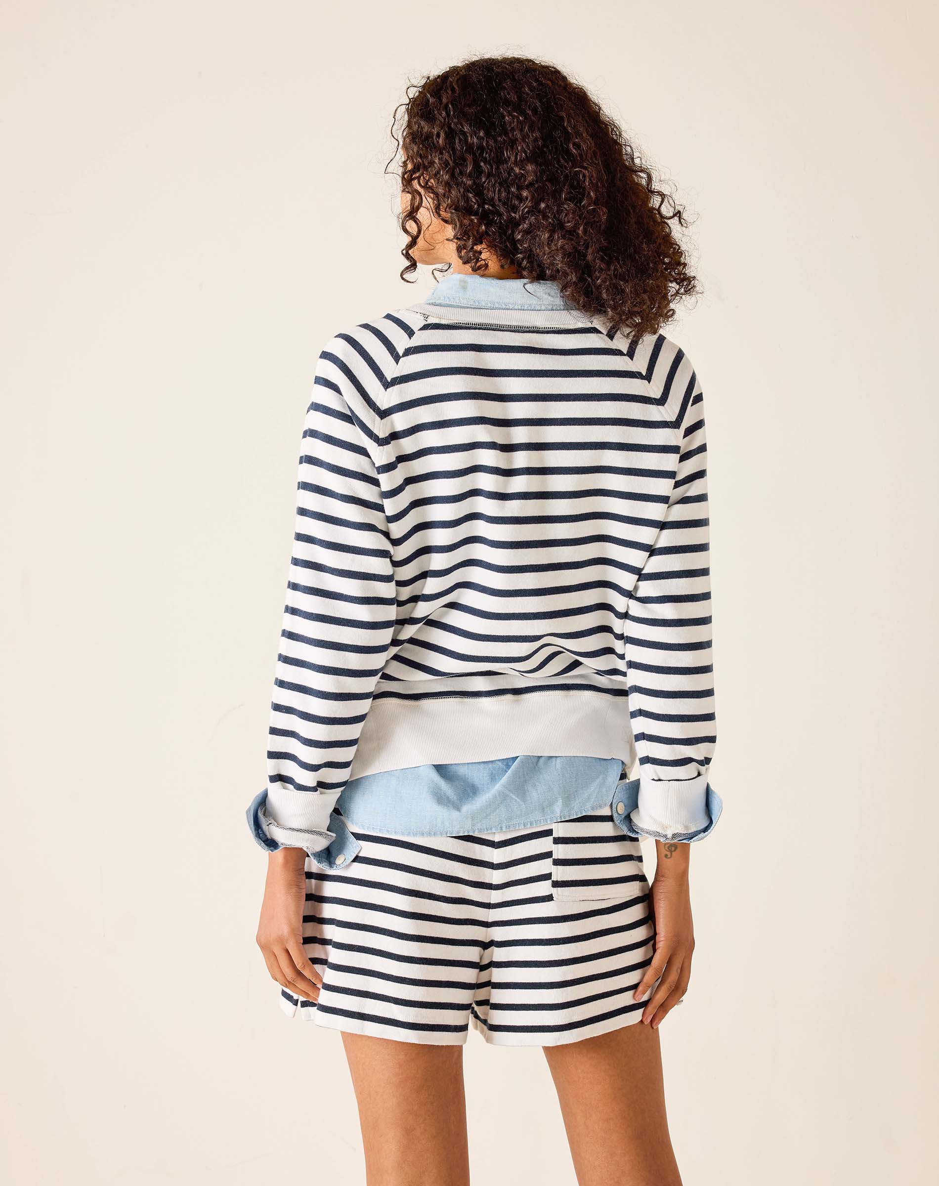 Person wearing a striped outfit with a white background