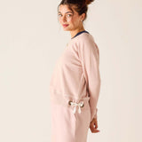 Woman wearing a pink outfit with a white background