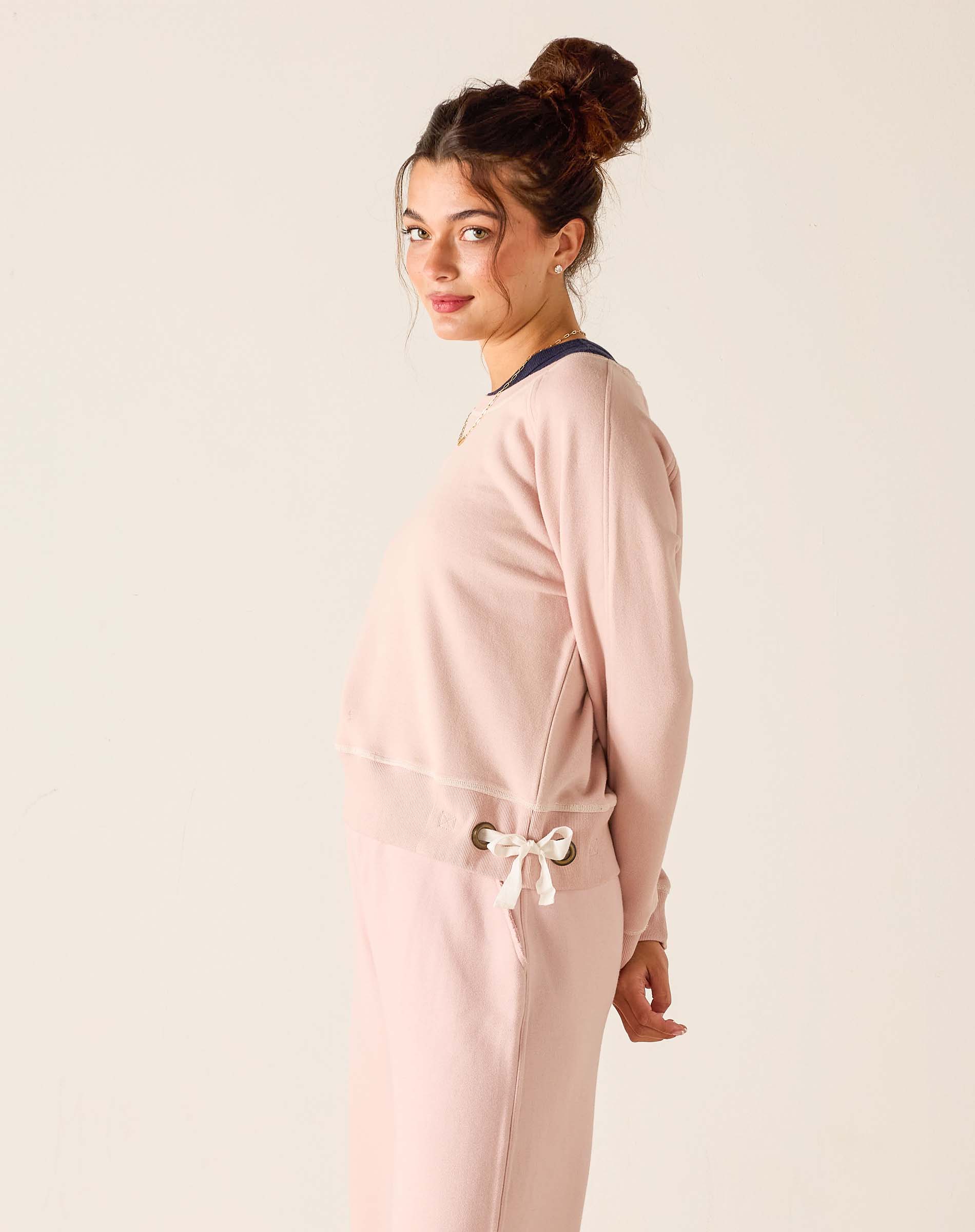 Woman wearing a pink outfit with a white background