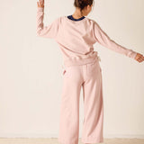 Woman wearing a pink outfit with a neutral background