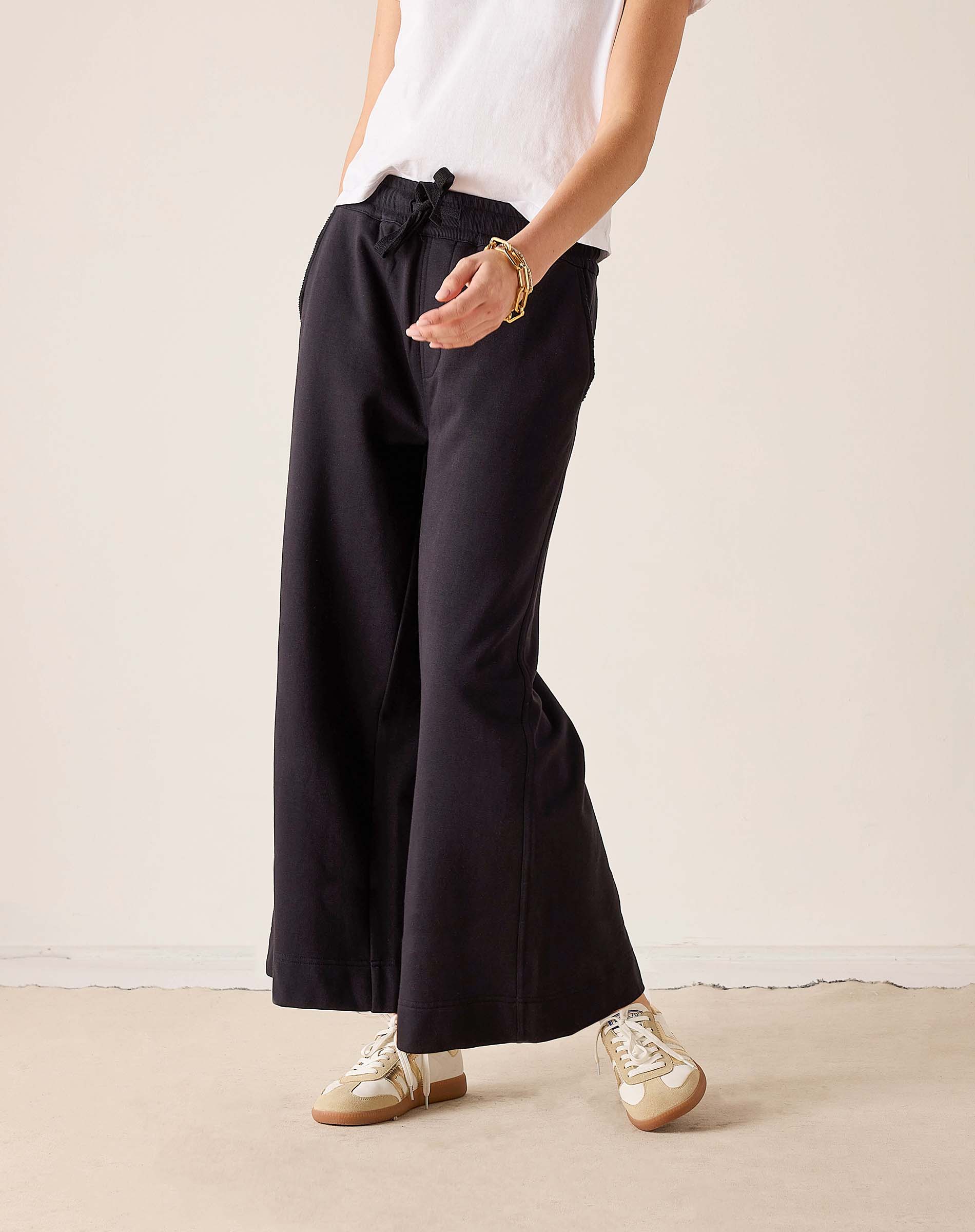 Black wide-leg trousers with a high-waist and drawstring waist.