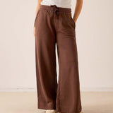 Espresso wide-leg pants in a soft knit fabric with a drawstring waist and full-length silhouette.