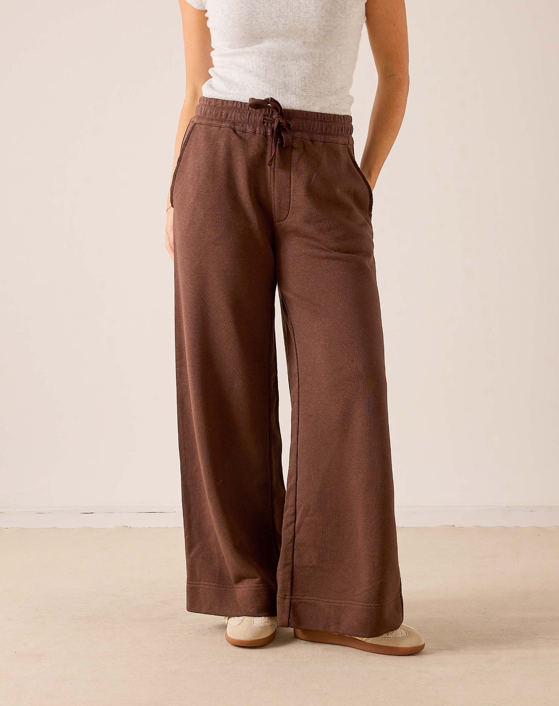 Espresso wide-leg pants in a soft knit fabric with a drawstring waist and full-length silhouette.